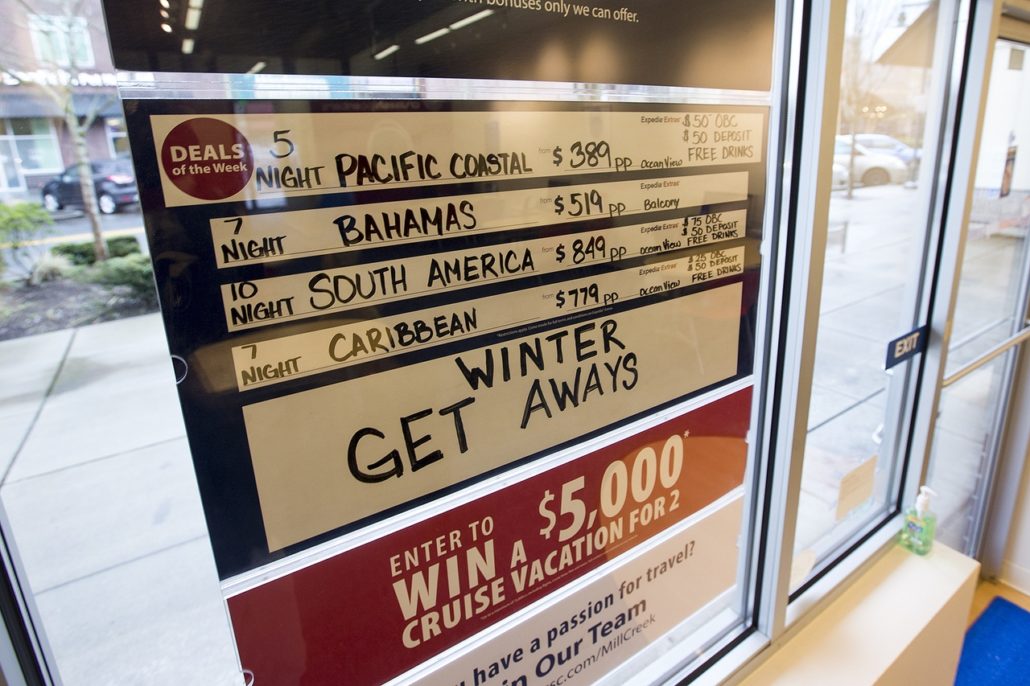 A board listing current cruise ship vacation deals is seen at an Expedia CruiseShipCenters franchise in Mill Creek Town Center. (Ian Terry / The Herald)